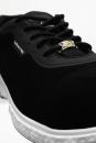 Preview: The shoe is black with a smooth surface. It has laces and a white rubber sole with texture. On the side is the brand name 