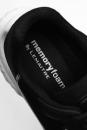 Preview: The image shows the inside of a black shoe with a soft, padded insert. On the insert, the text 