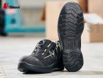 Preview: The image shows a black safety shoe with yellow accents. The sole has a textured profile for better grip. The shoe features a quick lacing system and appears sturdy.