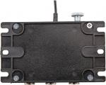 Preview: The image shows a flat, rectangular, black device with a slightly textured surface. At the top, there is a cable and a rotary knob. Hexagonal screws are visible at the corners.