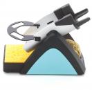 Preview: The image shows a pen in a holder. It is gray and black in color, with a yellow sponge underneath. The holder has a triangular shape and is stable.