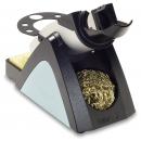 Preview: The image shows an electric pencil sharpener. It has a trapezoidal base in dark blue with a silver front. On top, there is a rotating mechanism with a holder for the pencil.