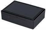 Preview: Das Bild zeigt eine rechteckige, schwarze Box aus Kunststoff. Sie hat einen flachen Deckel und eine glatte Oberfläche, die leicht glänzt. Die Box wirkt schlicht und modern.