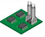 Preview: The image shows a green circuit board with four rectangular chips mounted on the surface. Two metallic connectors protrude from the top, which are used for connections.