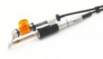 Preview: The image shows a tattoo device with a silver and black casing. It has an orange attachment and a long cable connection. The shape is slim and ergonomic.