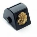 Preview: The image shows a small, black, wedge-shaped object with a round, golden surface texture. It has a smooth side and a lateral adjustment screw.