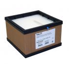 Preview: The image displays a square, brown cardboard box with a black plastic frame. At the top, a white, textured surface is visible. On the front, there is a label with technical information.