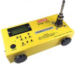 Preview: The image shows a yellow, rectangular measuring device with a digital display, buttons, and an antenna connection on top. It has two round, black feet on the bottom.