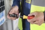 Preview: Two hands holding different screwdrivers: one black with 