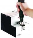 Preview: The image shows an automatic screw machine with a handle holding a screwdriver. The machine has a rectangular shape with a shiny surface.