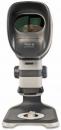 Preview: The image shows a medical device for eye examinations. It has an oval, black frame with a lens at the front, and a sturdy, gray base.