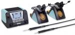 Preview: The image shows a soldering station with a digital display, two soldering tip holders, and two soldering tips. They are designed in black and turquoise blue, with a placed sponge cleaning.