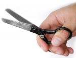 Preview: The image shows a hand holding a black pair of scissors. The scissors have two shiny blades and an ergonomic handle. The name 