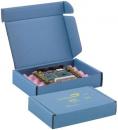 Preview: The image shows a blue package that is open and contains a circuit board. The board is placed on soft, pink foam and is securely packaged. Next to the open box lies another closed box.