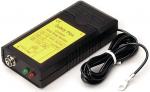 Preview: The image shows a black security device with yellow labeling. It has a connection on the front, two colored LEDs (red and green), and a cable leading out from the side.